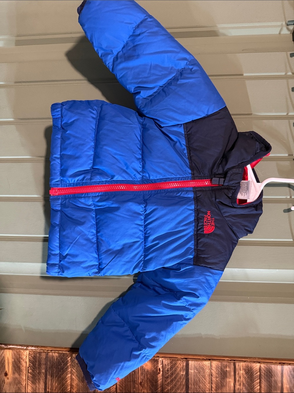 The North Face Kids Blue Puffer Jacket with Navy Yoke and Red Zipper